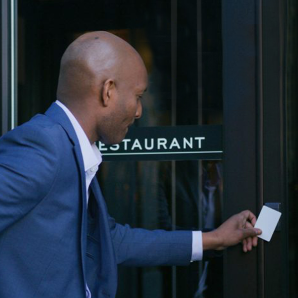 Restaurant owner opening up the front door using Guardian Alarm access control key pad and card