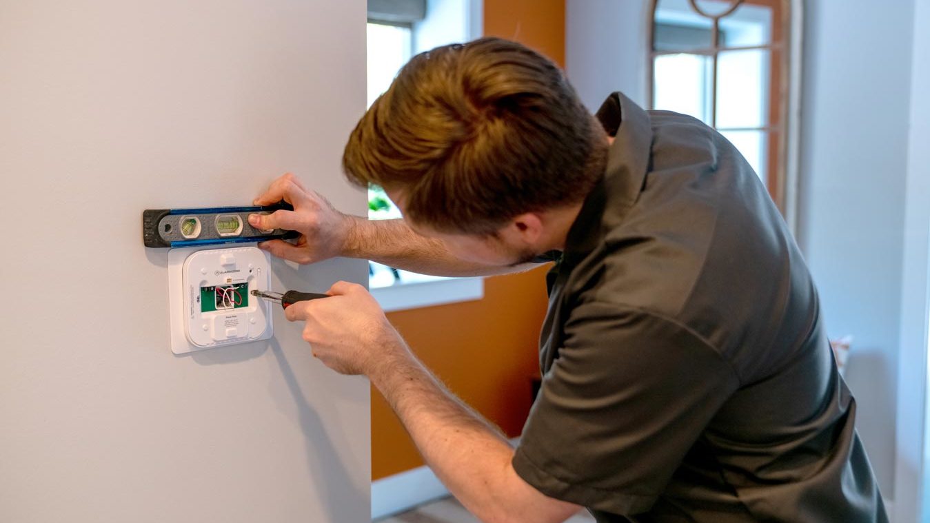 Technician properly installing a smart thermostat