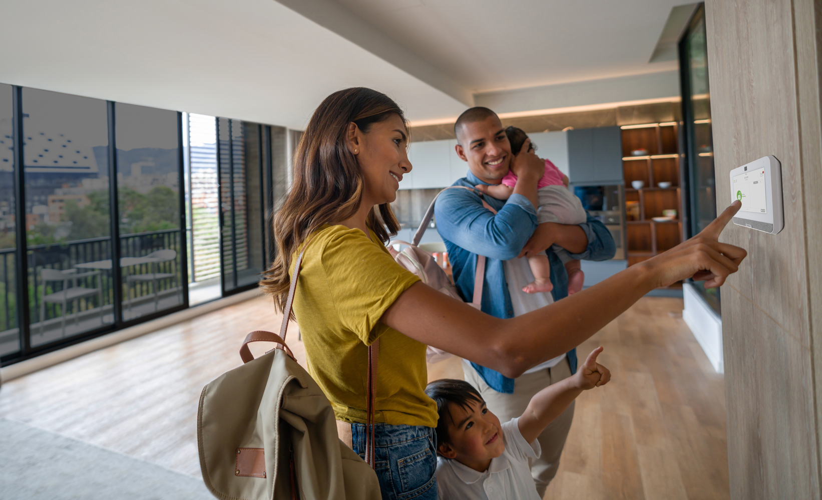 Family leaving house and setting Guardian Alarm panel