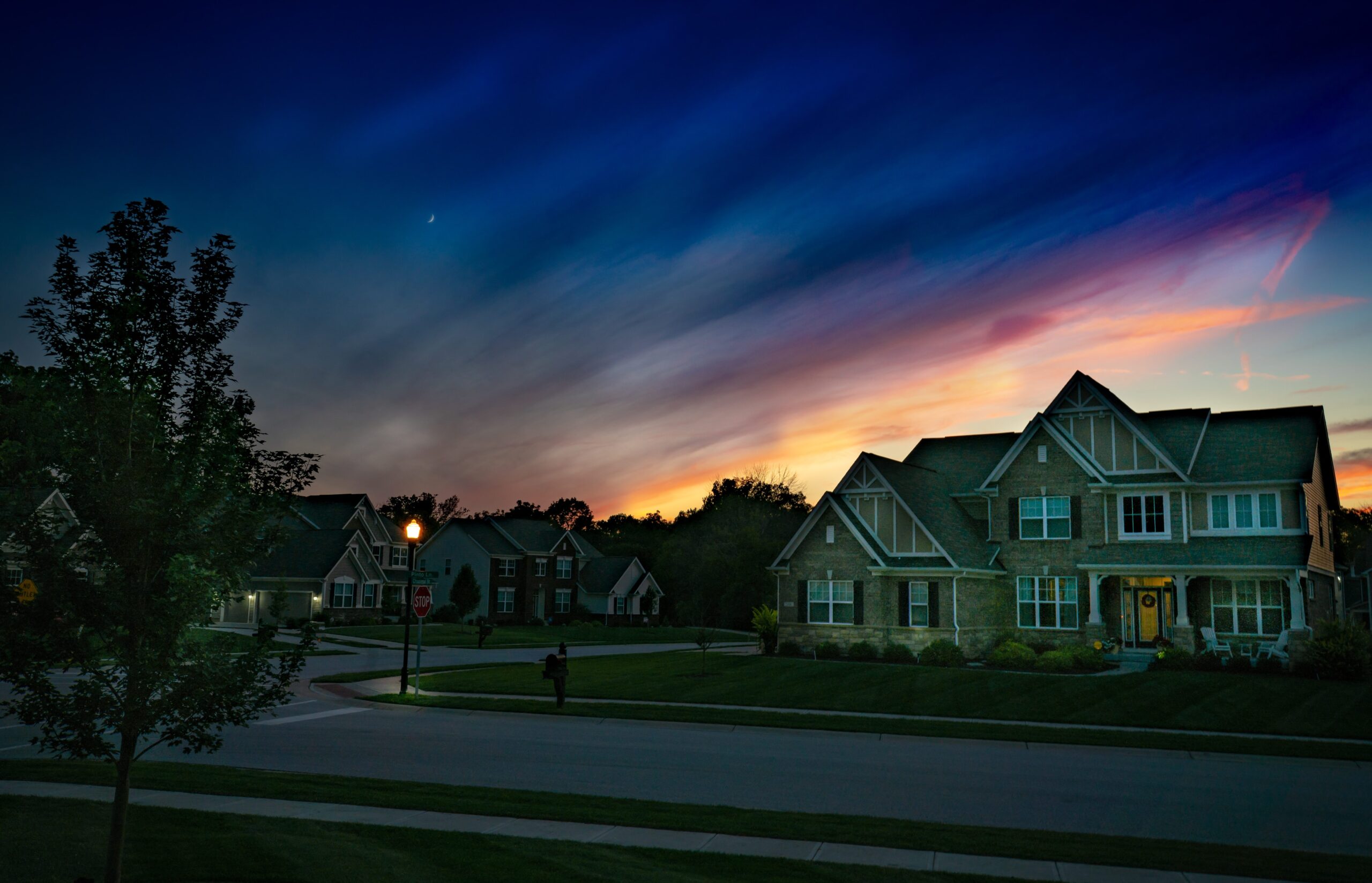 A quiet street with residential homes at dusk 